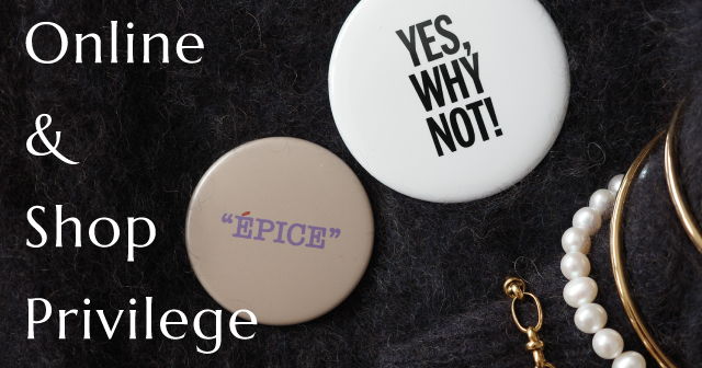 Buttons with phrases and jewelry on a dark background.