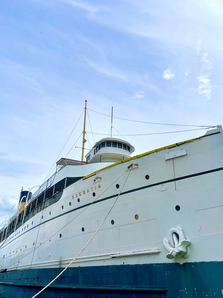 A large ship against a blue sky.