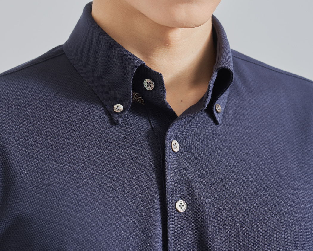 Close-up of a man's navy blue collared shirt.