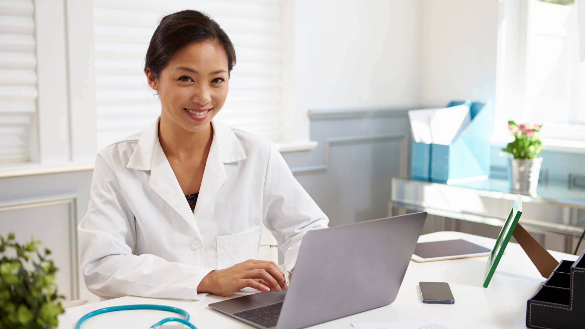 A woman practices good personal habits at her desk to maintain good posture.