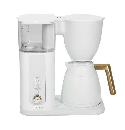 White coffee maker with a gold handle and transparent water reservoir.