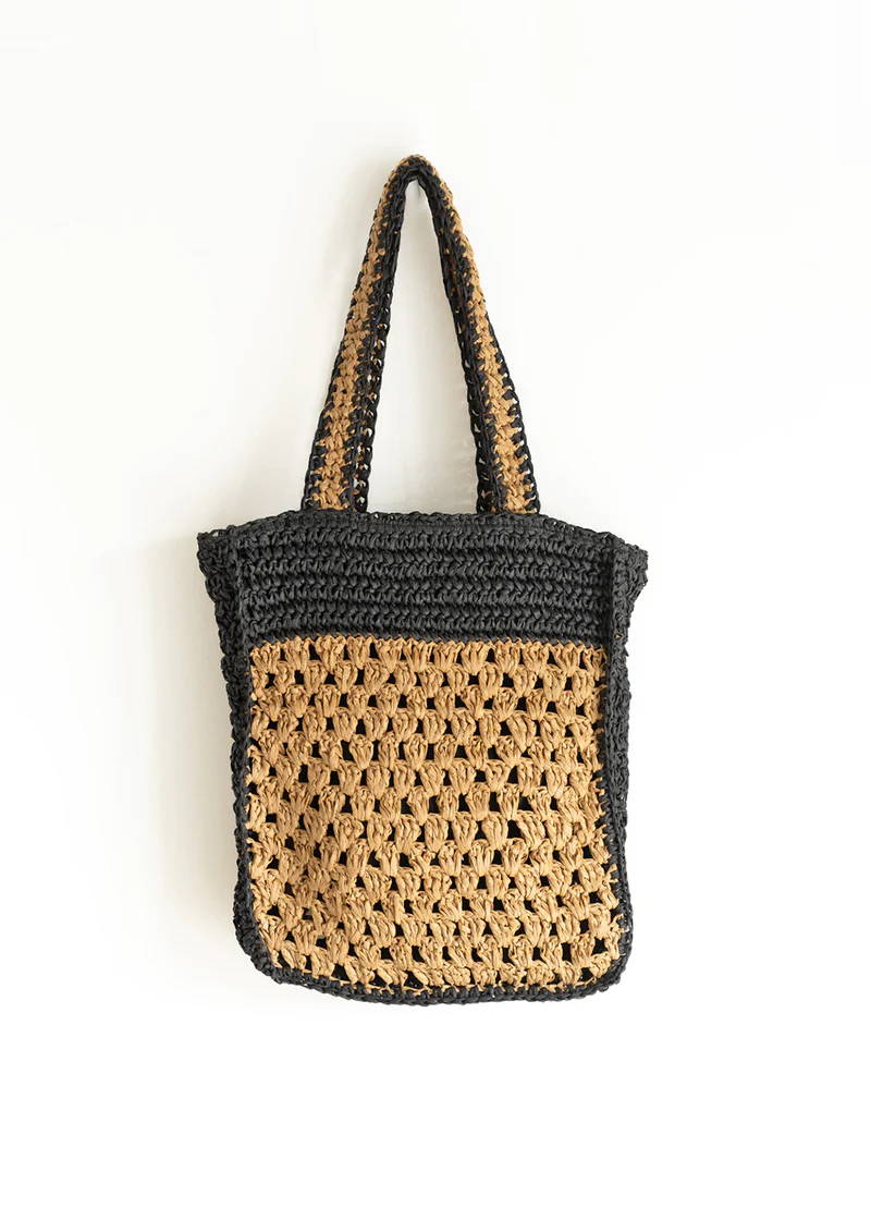 A natural brown and black crochet straw bag 