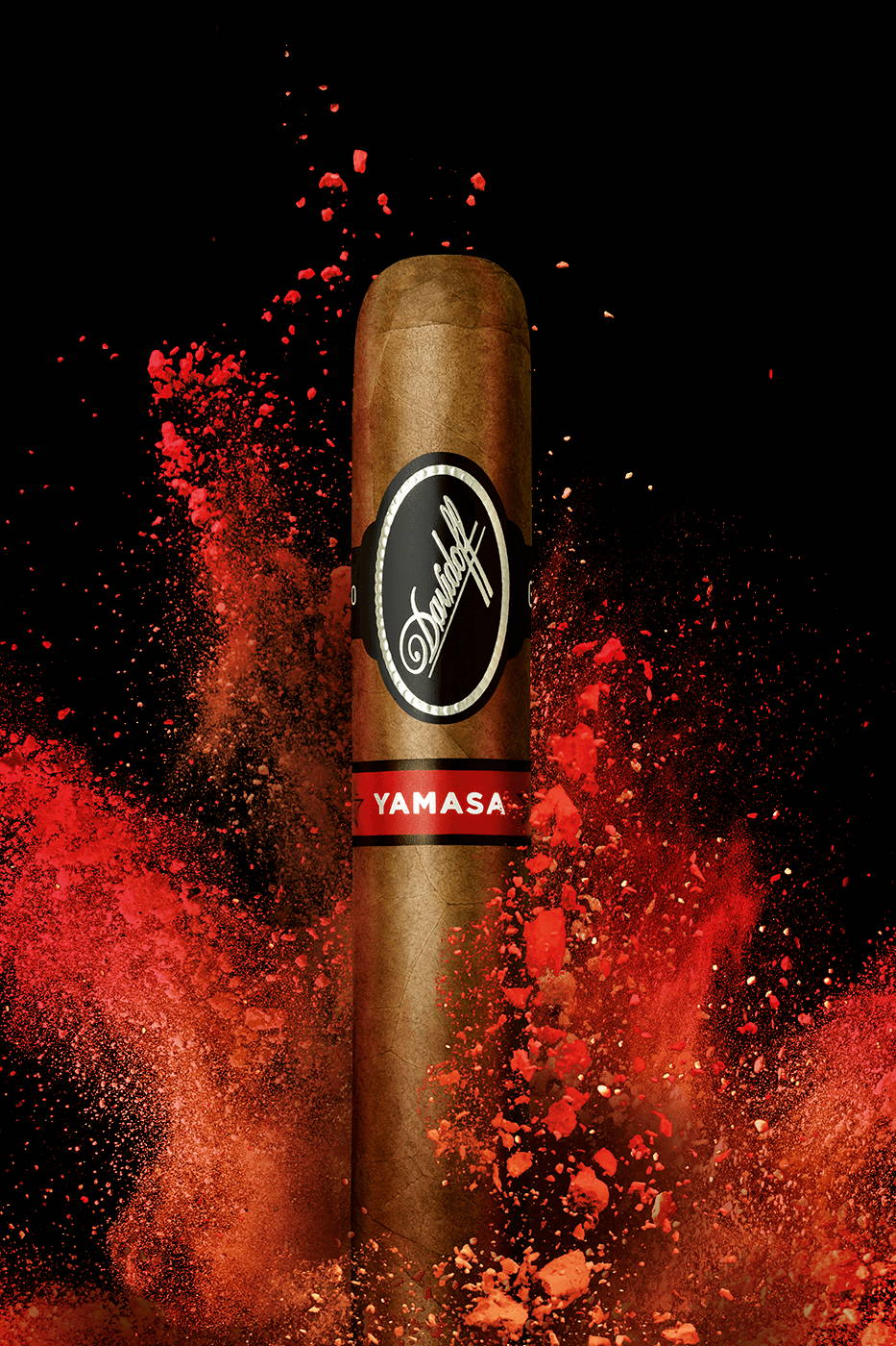 A Davidoff Yamasá cigar standing upright in front of a splash of bright red colour.