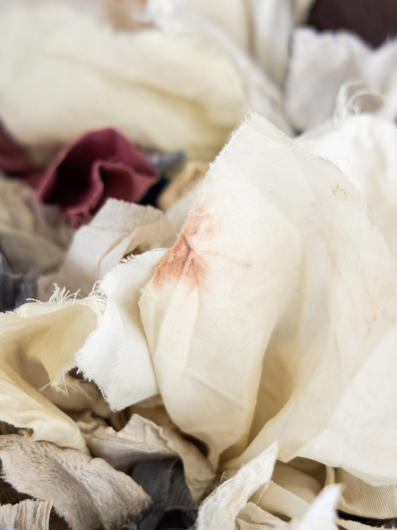 A pile of assorted fabric scraps in various colors.