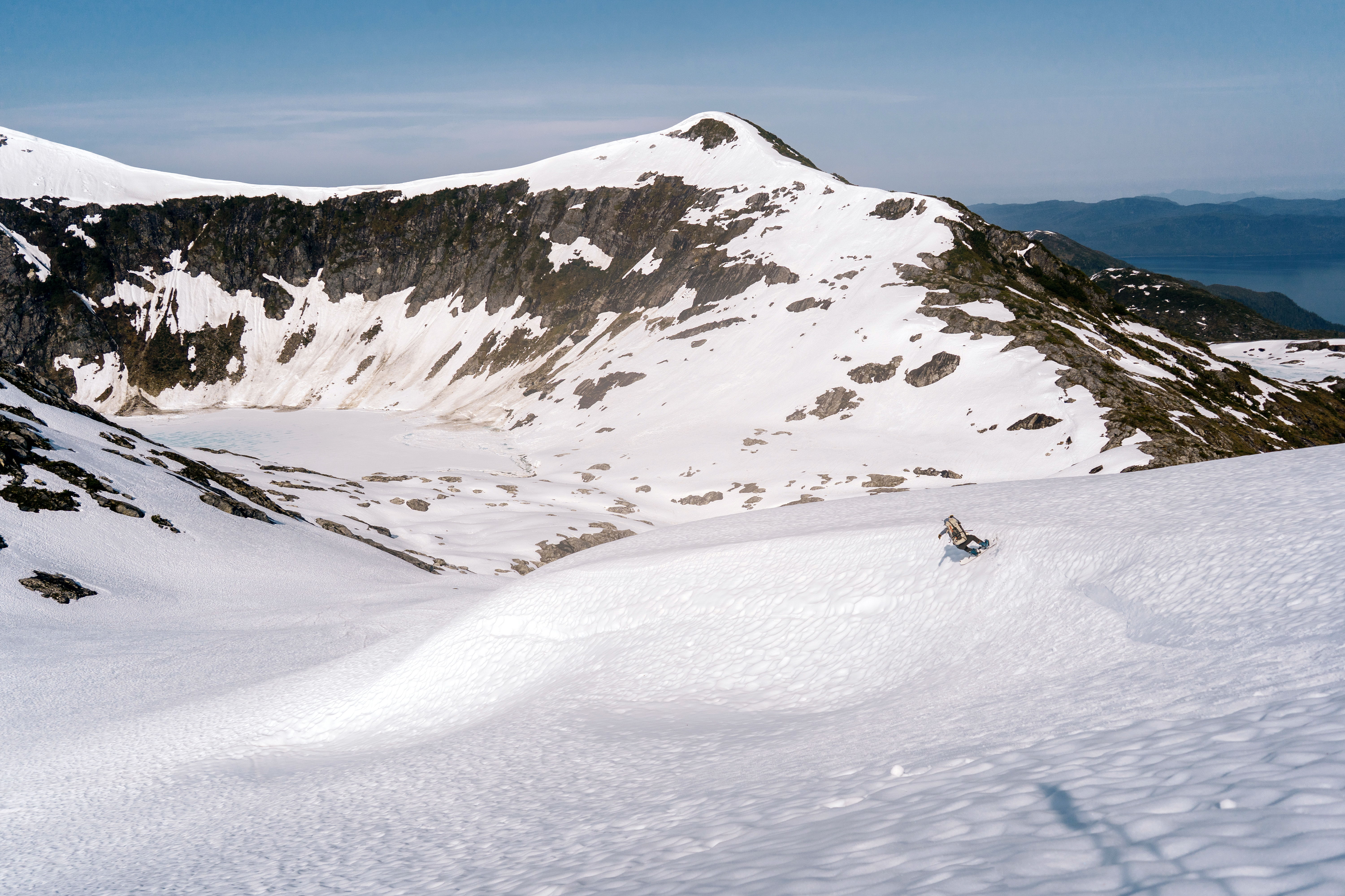 Snow-covered mountains under a clear blue sky.