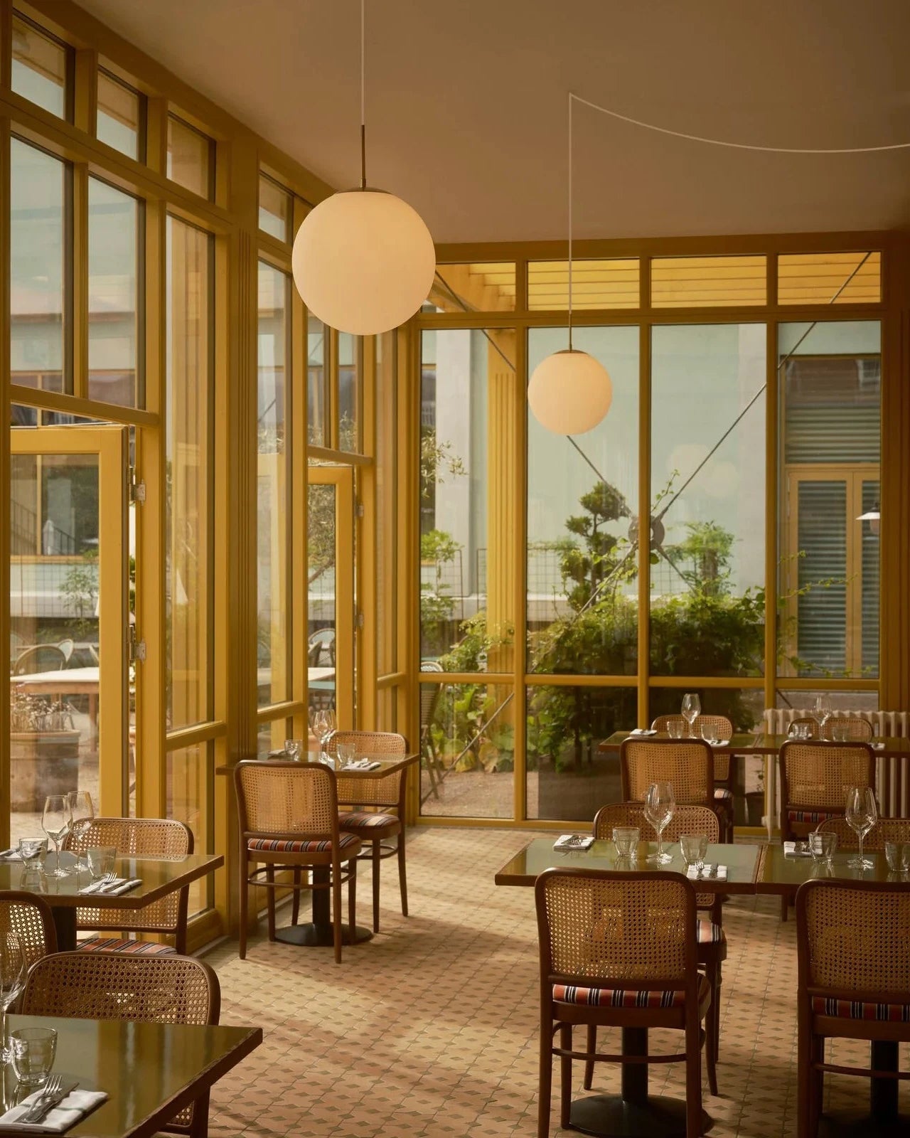 Simplistic Opal Sphere Pendant in Warm Restaurant Setting | Lighting Collective 