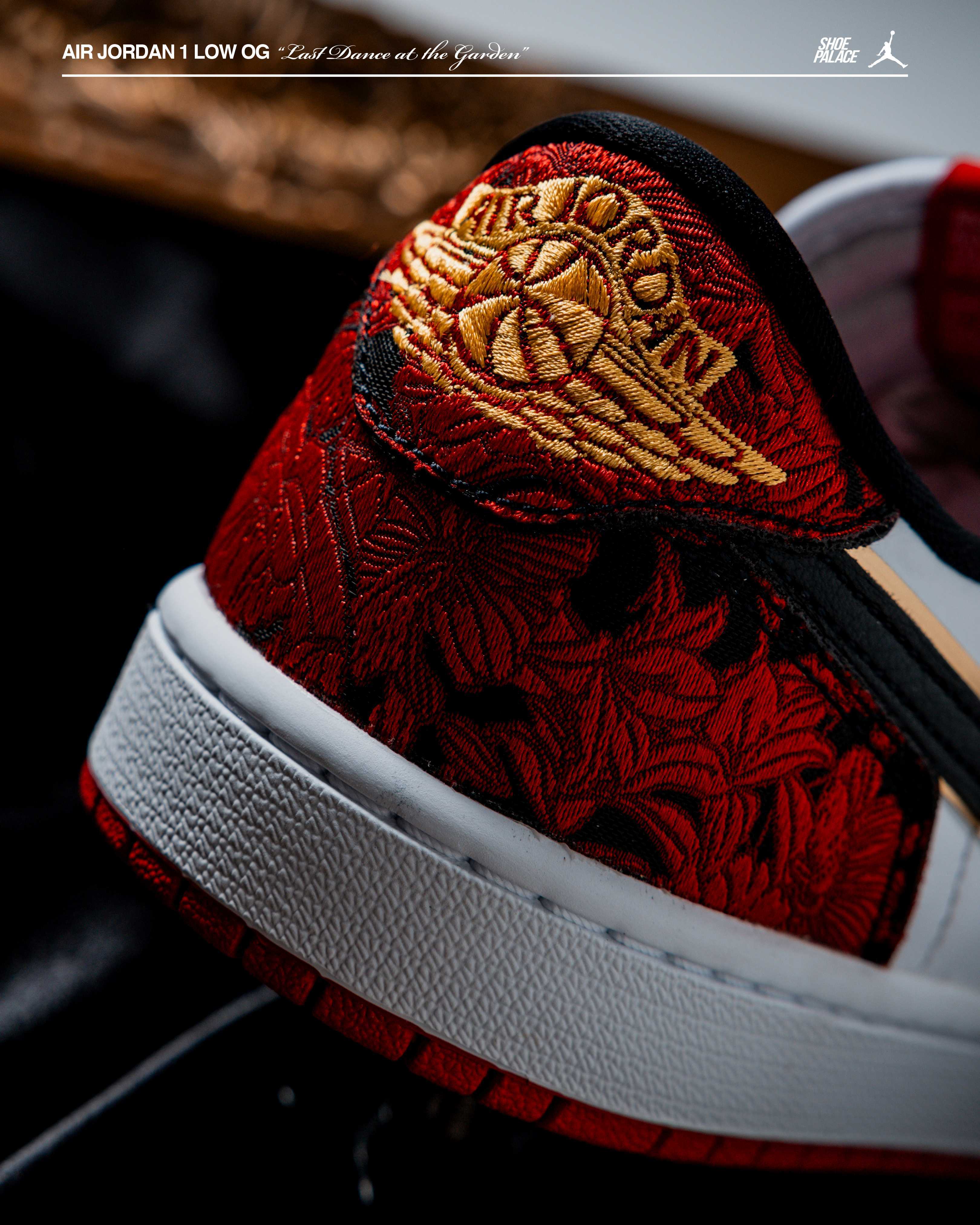 Close-up of a red Air Jordan sneaker with gold detailing.