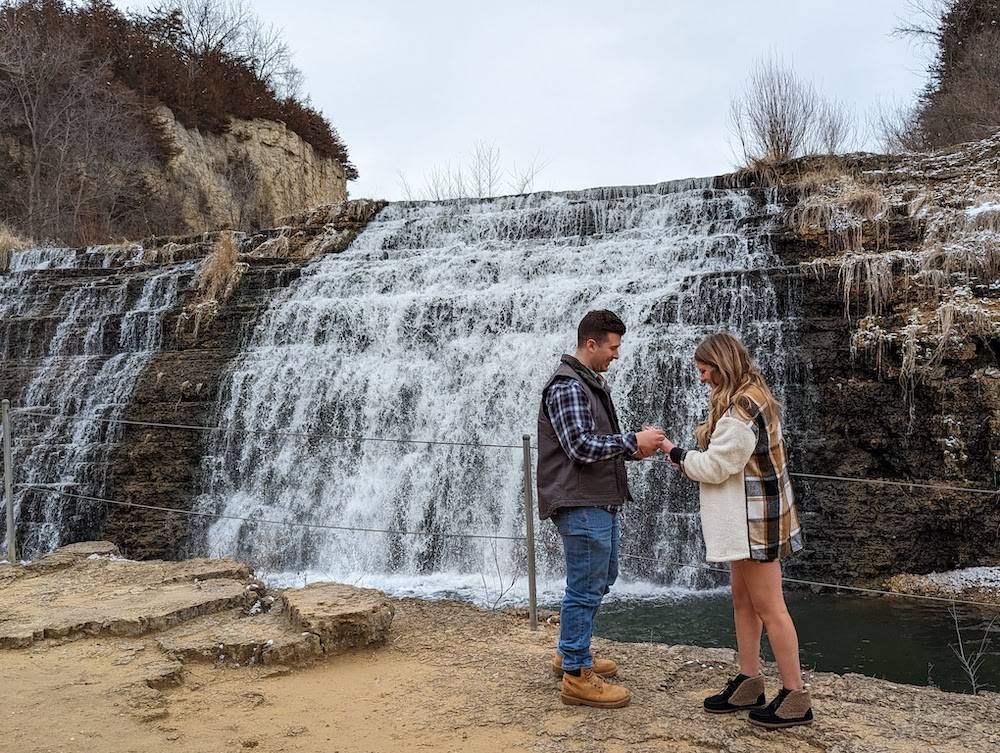 engagement in front of waterfall