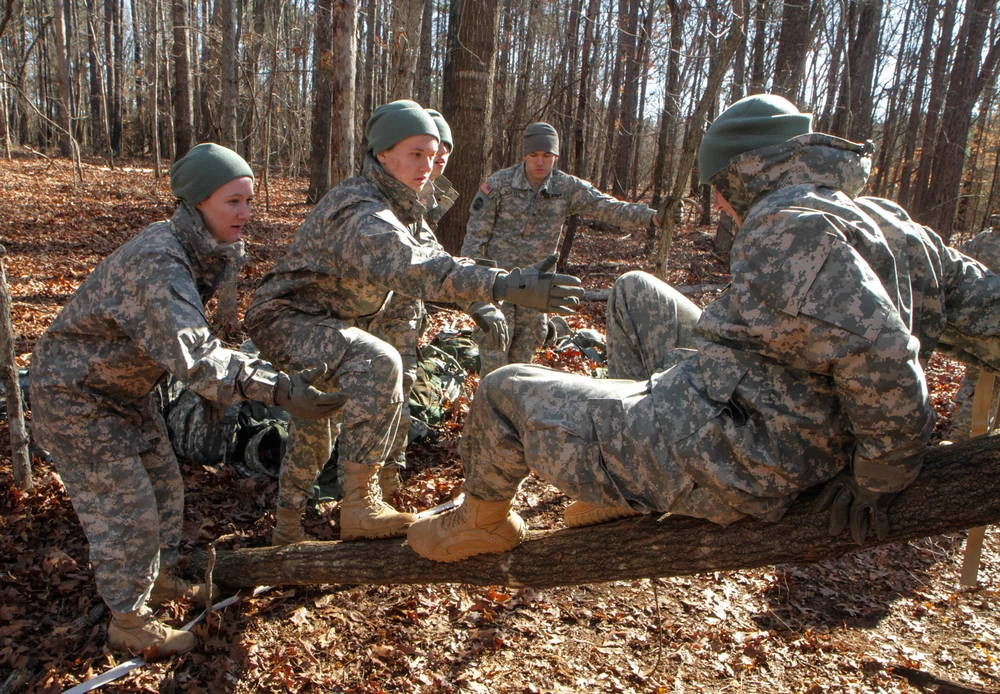 Clemson University Reserve Officer Training Corps cadets attempt to get themselves and all their gear over an obstacle without touching the ground using only two logs, March 7, 2015. The event was part of a field training exercise conducted by the Clemson ROTC in which junior cadets were tested on several team-building and leadership challenges. (U.S. Army photo by Sgt. Ken Scar)