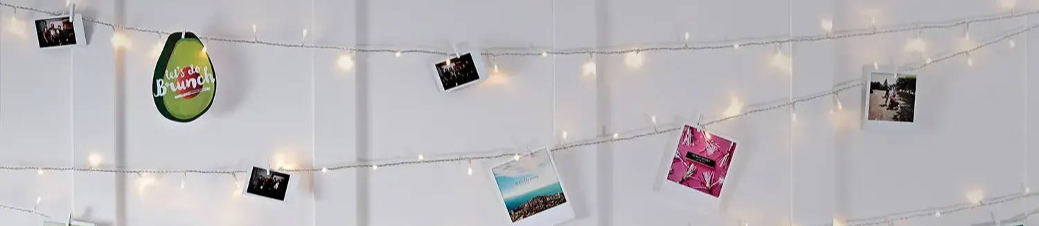 Fairy light wall illuminated with images attached to it
