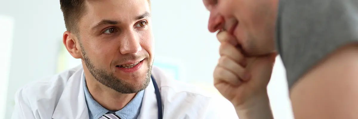A doctor talking to a patient in a medical setting.