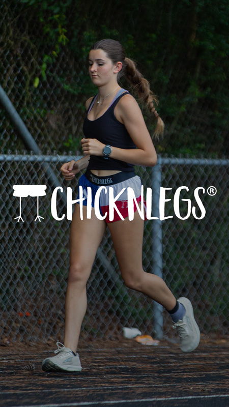A young woman jogging on a track.