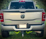 Rear view of silver RAM Laramie 4x4 with lime green badges and five green train horns mounted under bumper