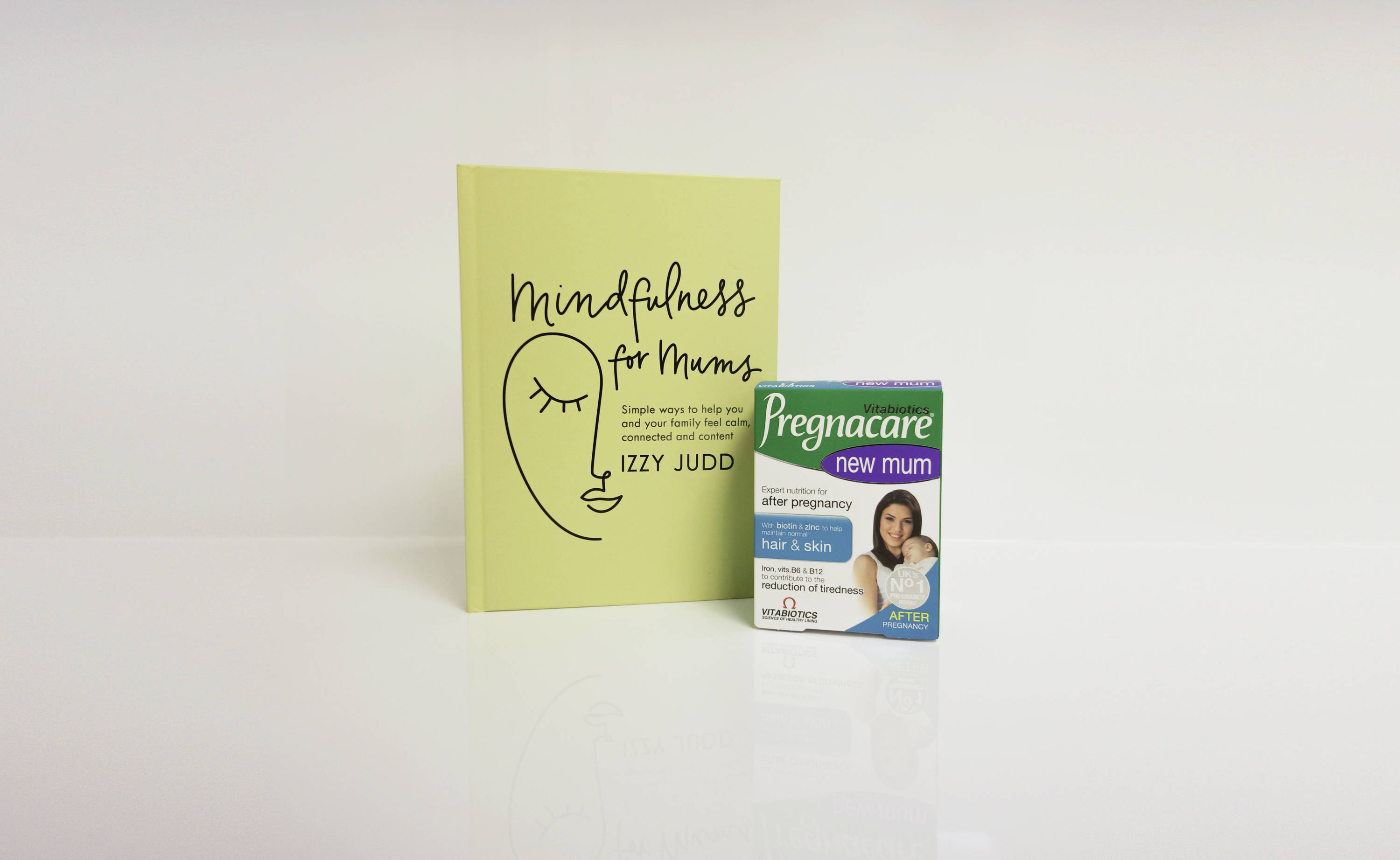 Book And Pregnacare Product On White Background
