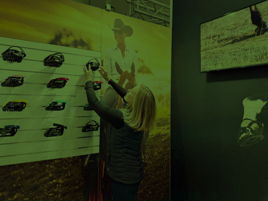 Person adjusting items on a display board in a store.
