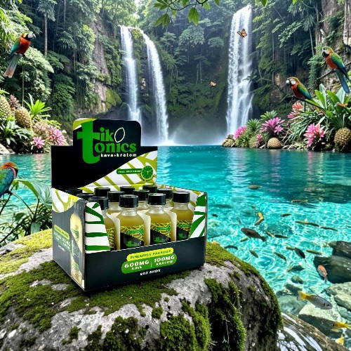 A box of tonic bottles near a tropical waterfall and turquoise water.