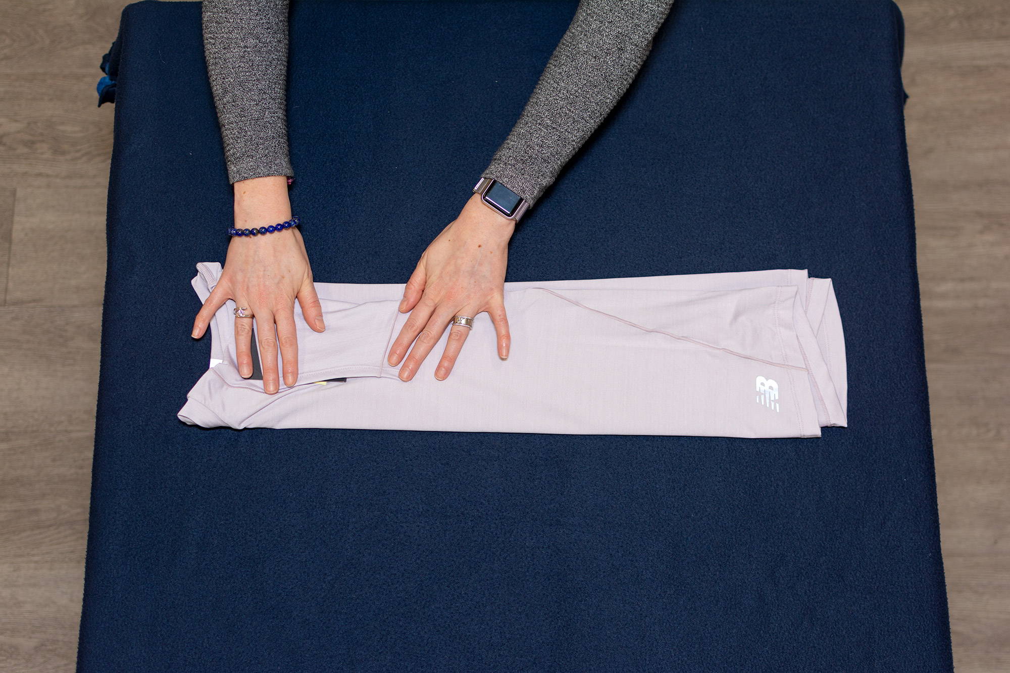 hands folding short-sleeved tee