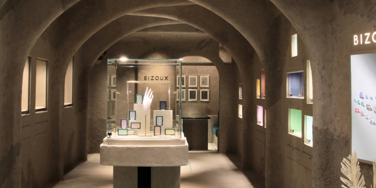 Art gallery interior with display cases and illuminated walls.
