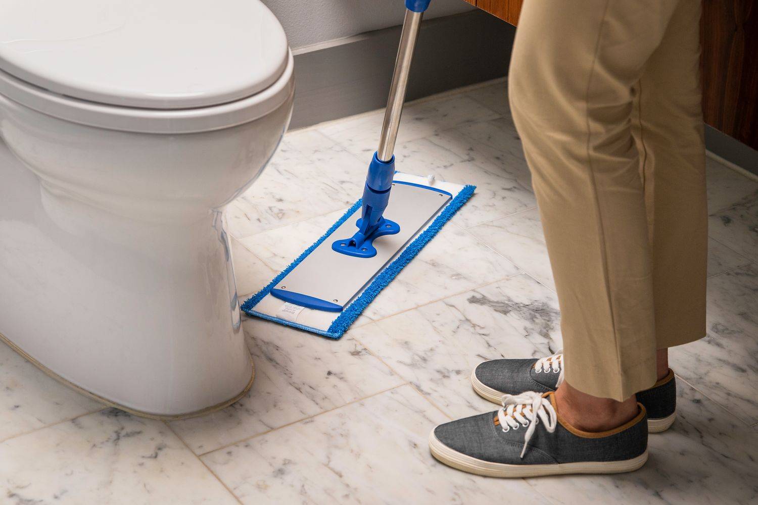 Person cleaning floors using a microfiber flat mop