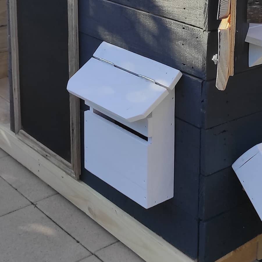 Letterbox installed on a cubby house's external wall
