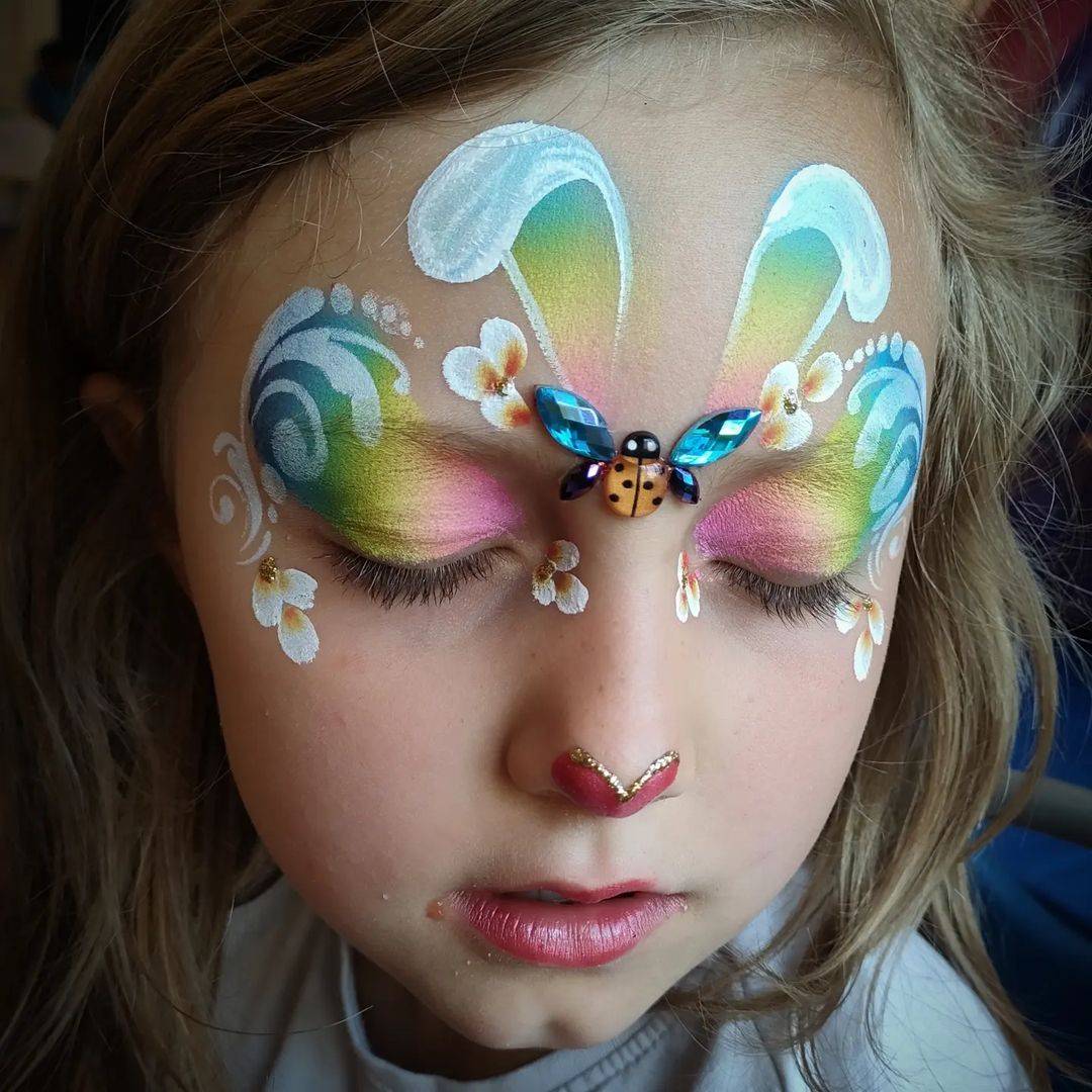 rainbow easter bunny face paint girl with heart nose 