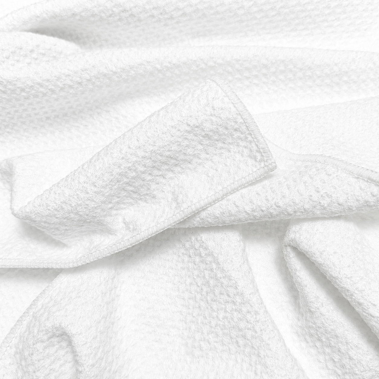 White textured fabric draped elegantly with a tied bow detail.