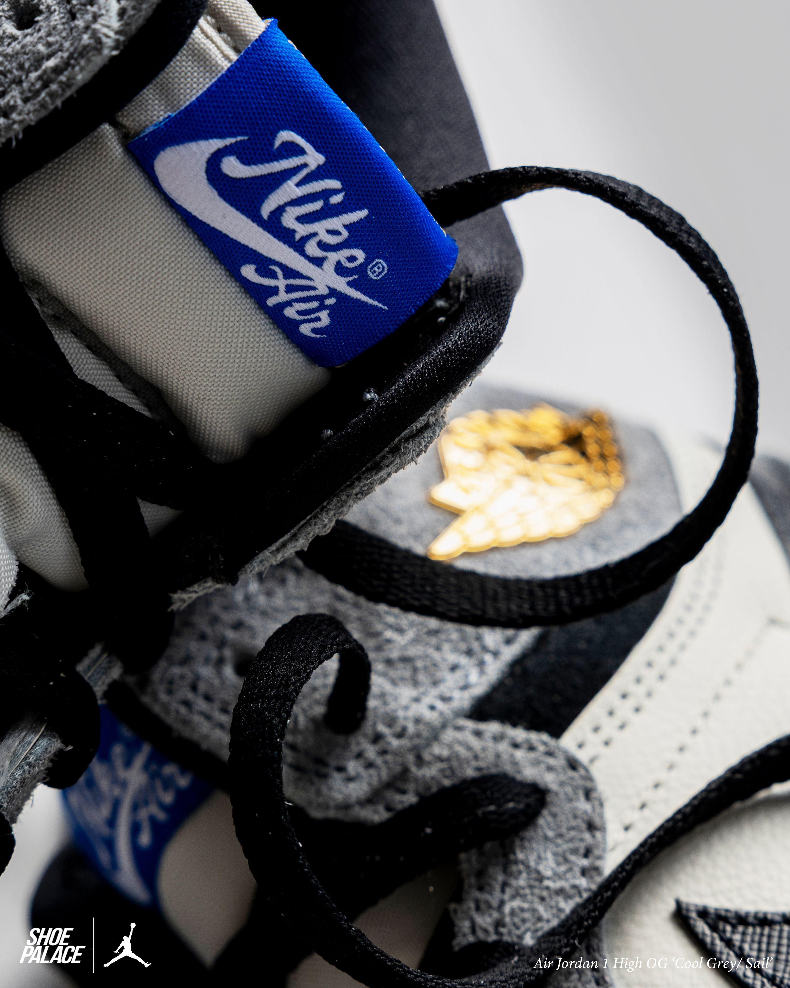 Air Jordan 1 Retro High OG - Close-up of Nike Air Jordan sneakers with blue and gold accents.