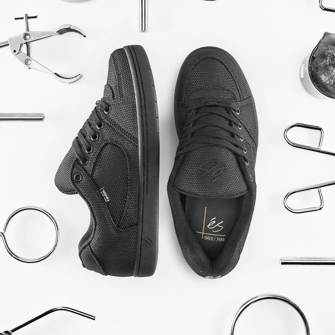 Black sneakers surrounded by various tools and objects.