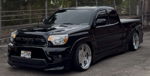 Front three-quarter black slammed Toyota Tacoma Xrunner chrome deep-dish wheels Hawaii ES945 TRD grille chain-link fence Jermyn's Flatlaw 127H featured gallery photo 1