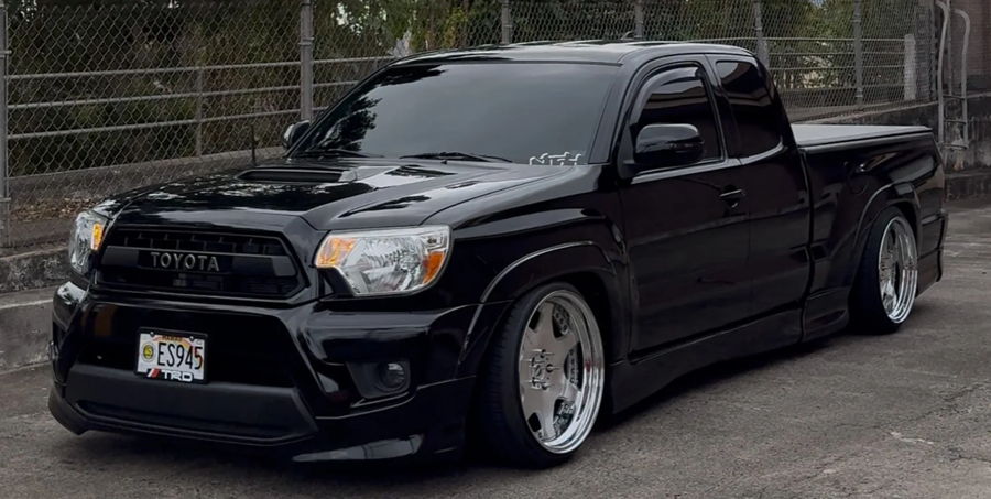 Front three-quarter black slammed Toyota Tacoma Xrunner chrome deep-dish wheels Hawaii ES945 TRD grille chain-link fence Jermyn's Flatlaw 127H featured gallery photo 1