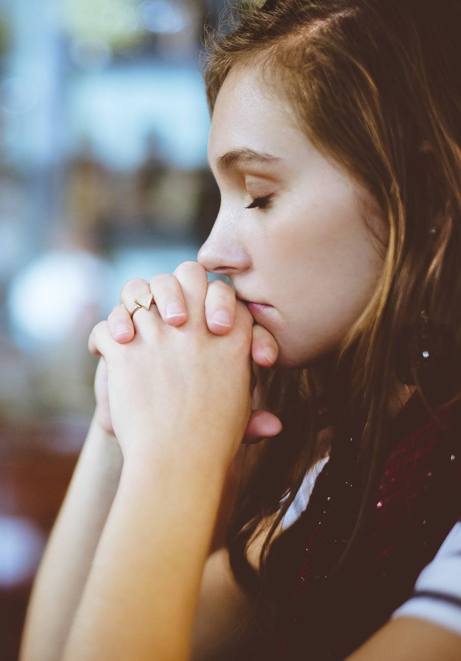 girl clasping her hands together