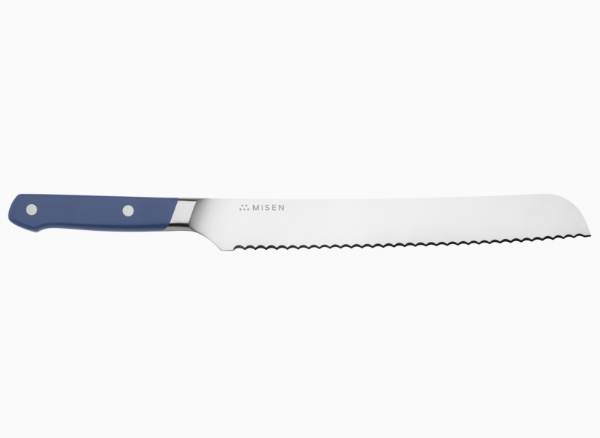 A blue Misen Serrated Knife seen from the side, with the Misen logo visible at the base of the knife’s spine.