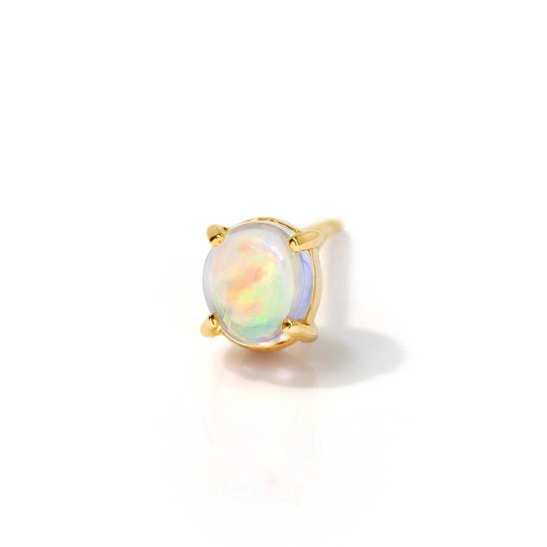 Gold ring with an opal gemstone in a simple setting.