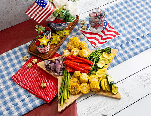 Star-shaped platter of colorful vegetables with festive decorations.