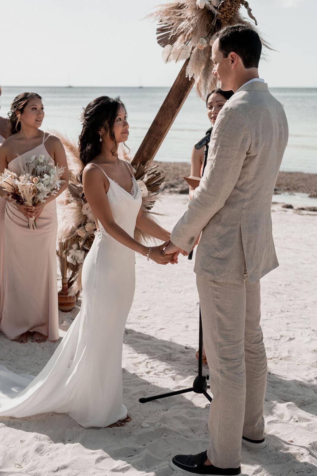 Bride and groom, exchanging vows on the beach