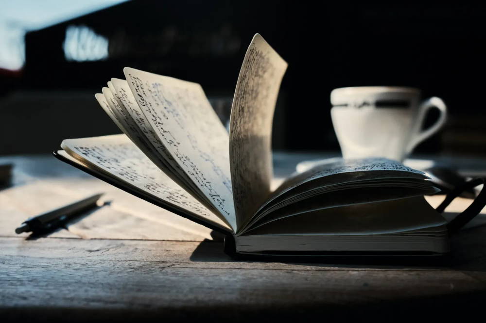 Open book on a brown wooden table