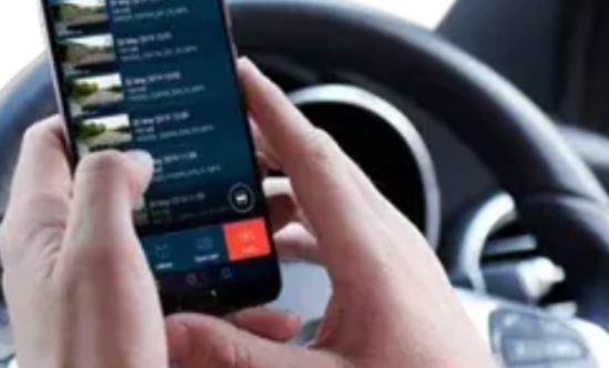 Person using a smartphone while sitting in a car.