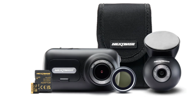 Camera and accessories, including lens and storage card, in a black case.