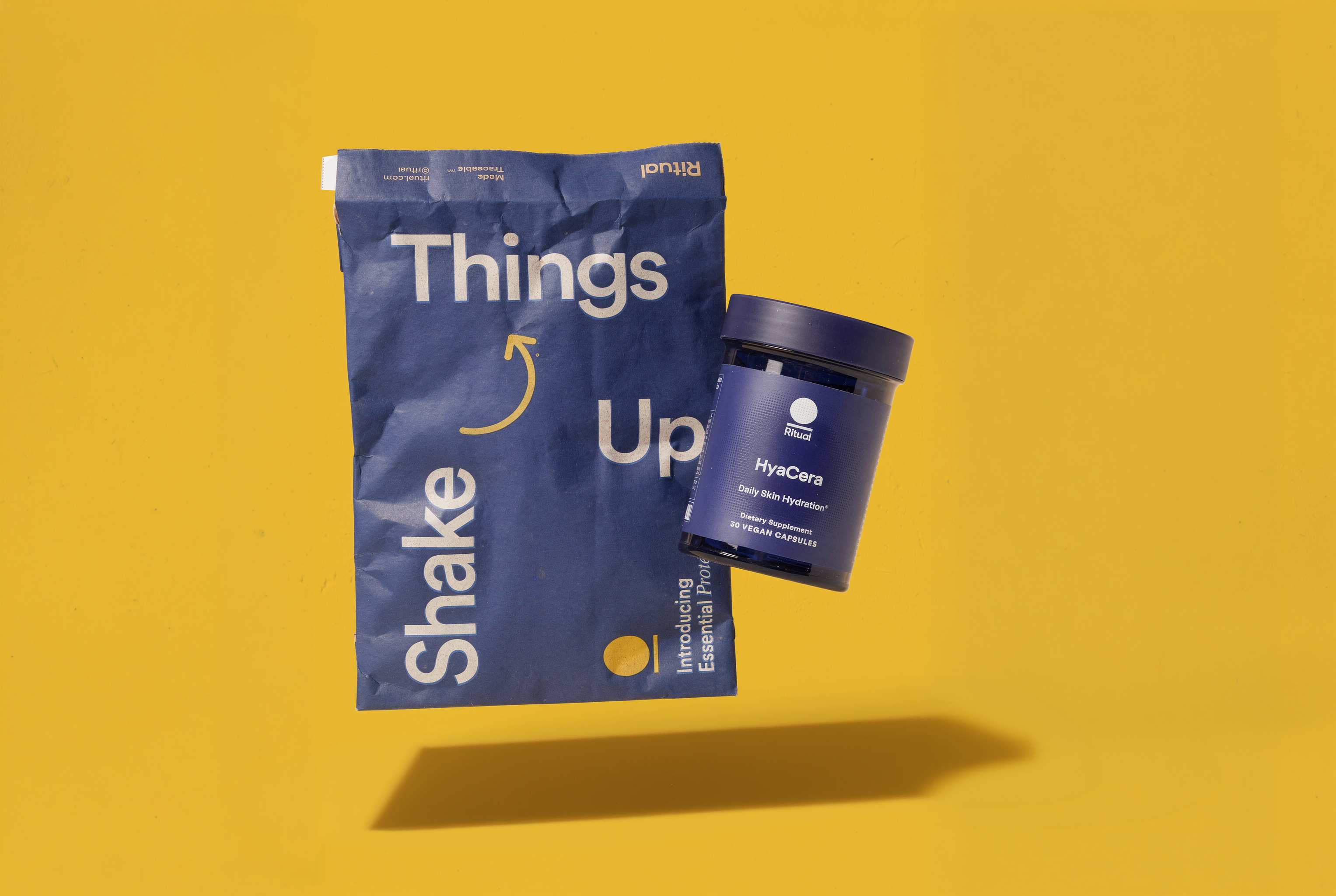 Ritual mailer and supplements jar on a yellow background.