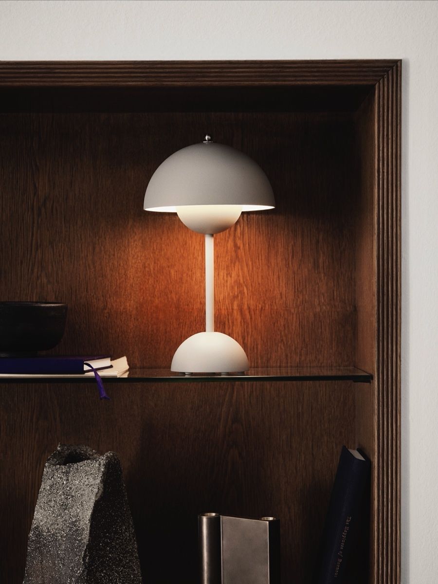A modern Flowerpot lamp &tradition on a shelf with a wooden background.