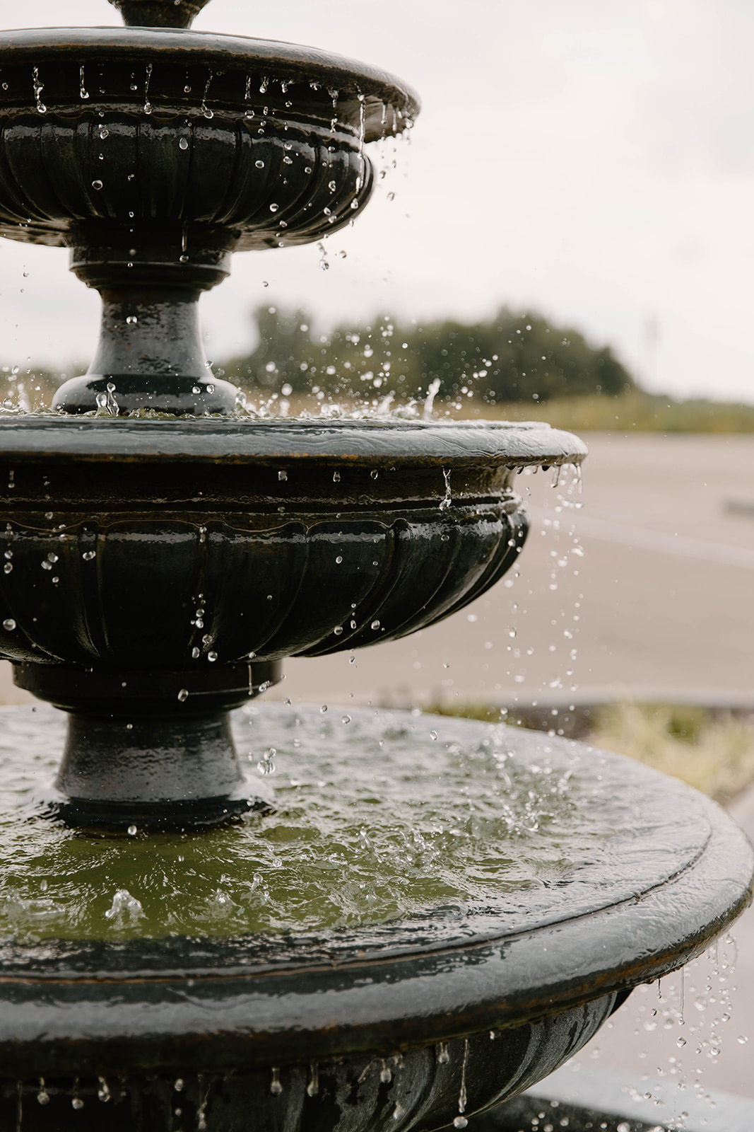 A decorative fountain with multiple tiers and water splashing.