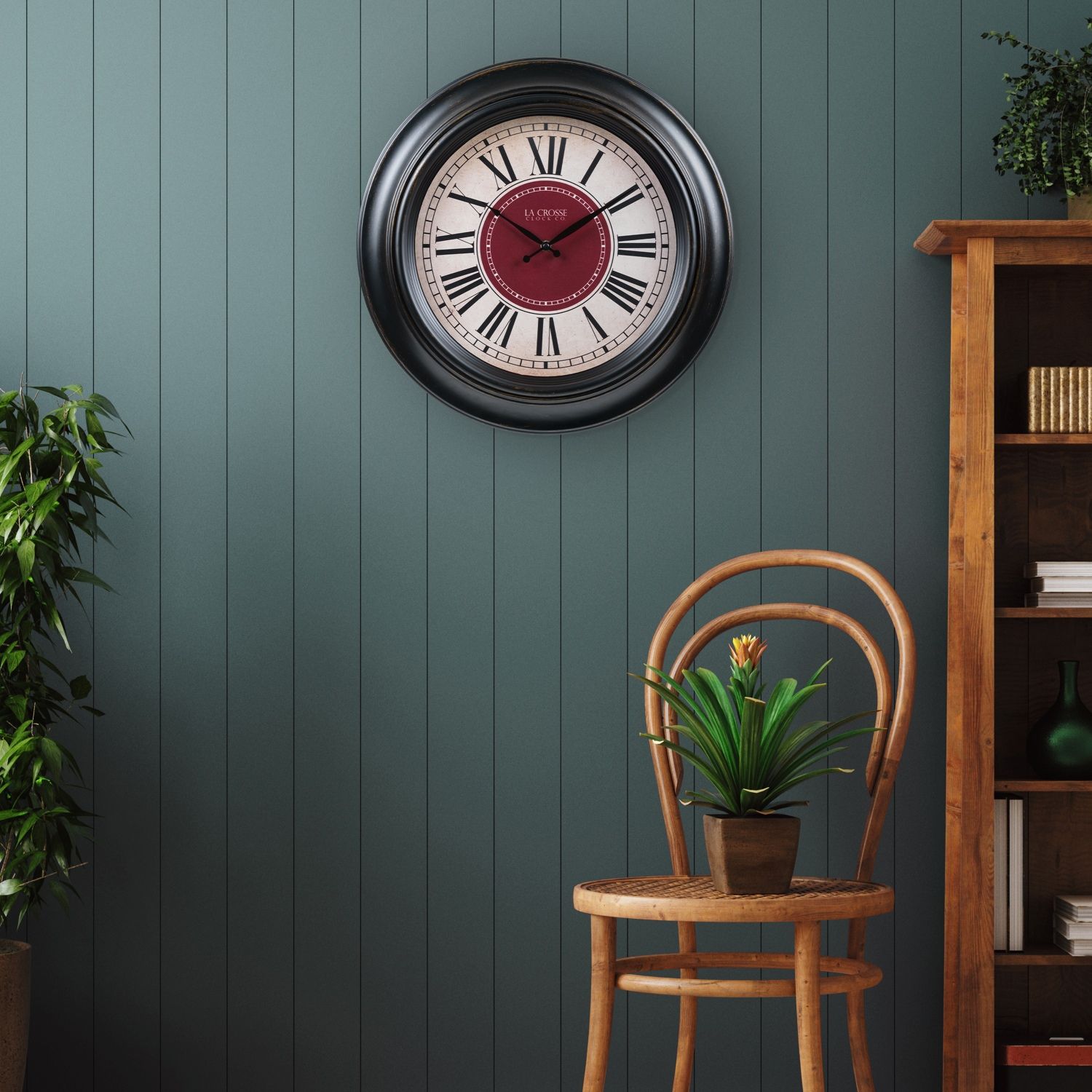 18-inch Barton Wall Clock, chair, plant, and bookshelf in a room.