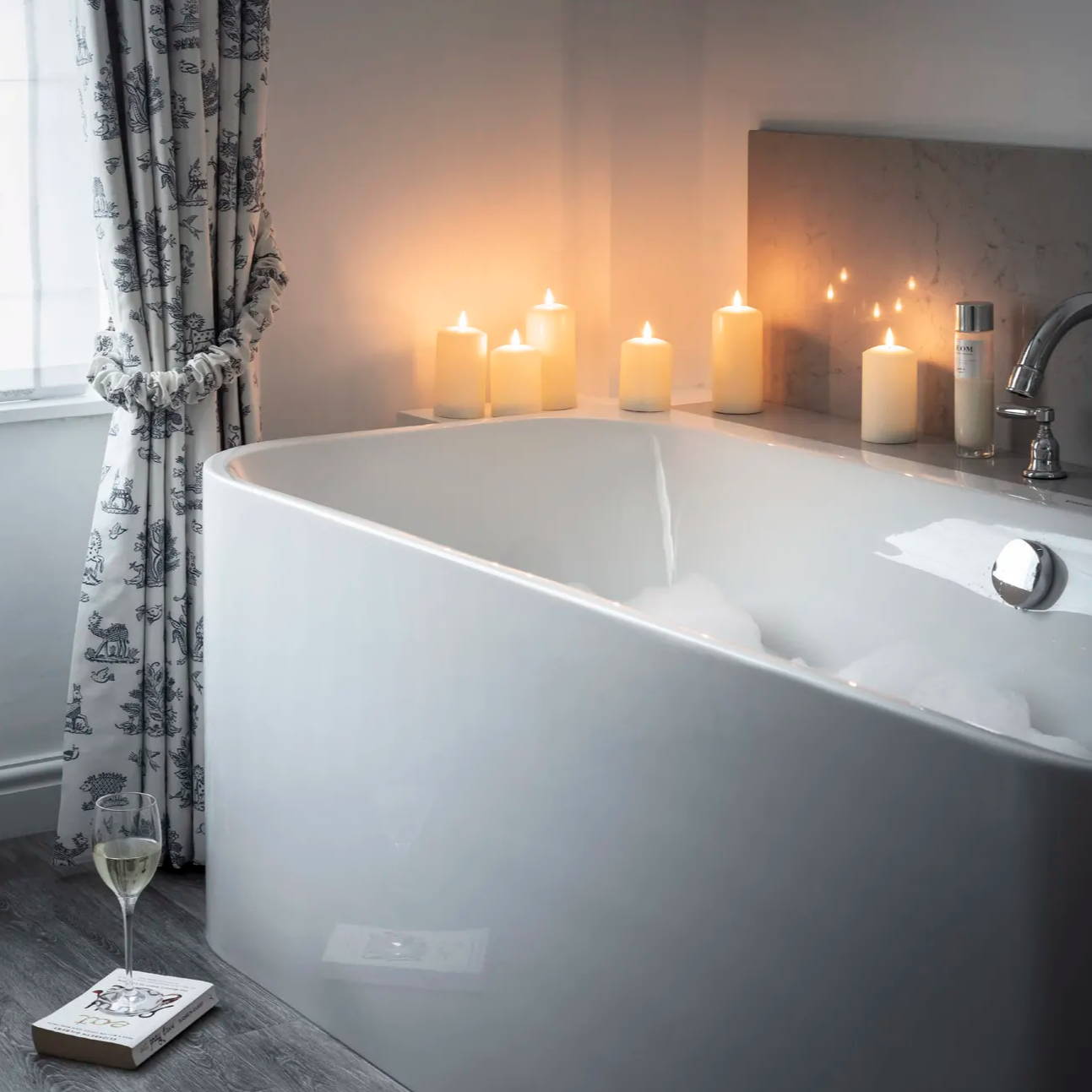 battery led pillar candles placed along the bath edge