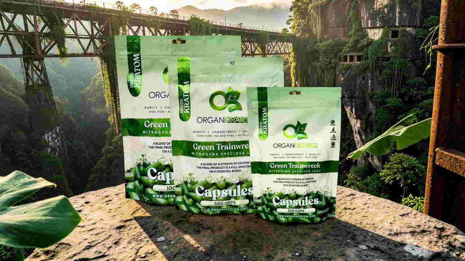 Packaging of green products displayed outdoors with a scenic backdrop.