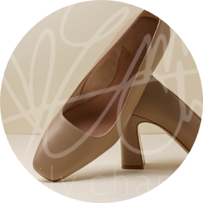Brown high-heeled shoes positioned at an angle on a light background.