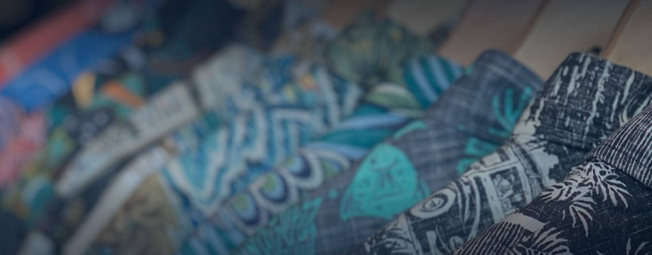 Colorful patterned fabrics arranged in a row.