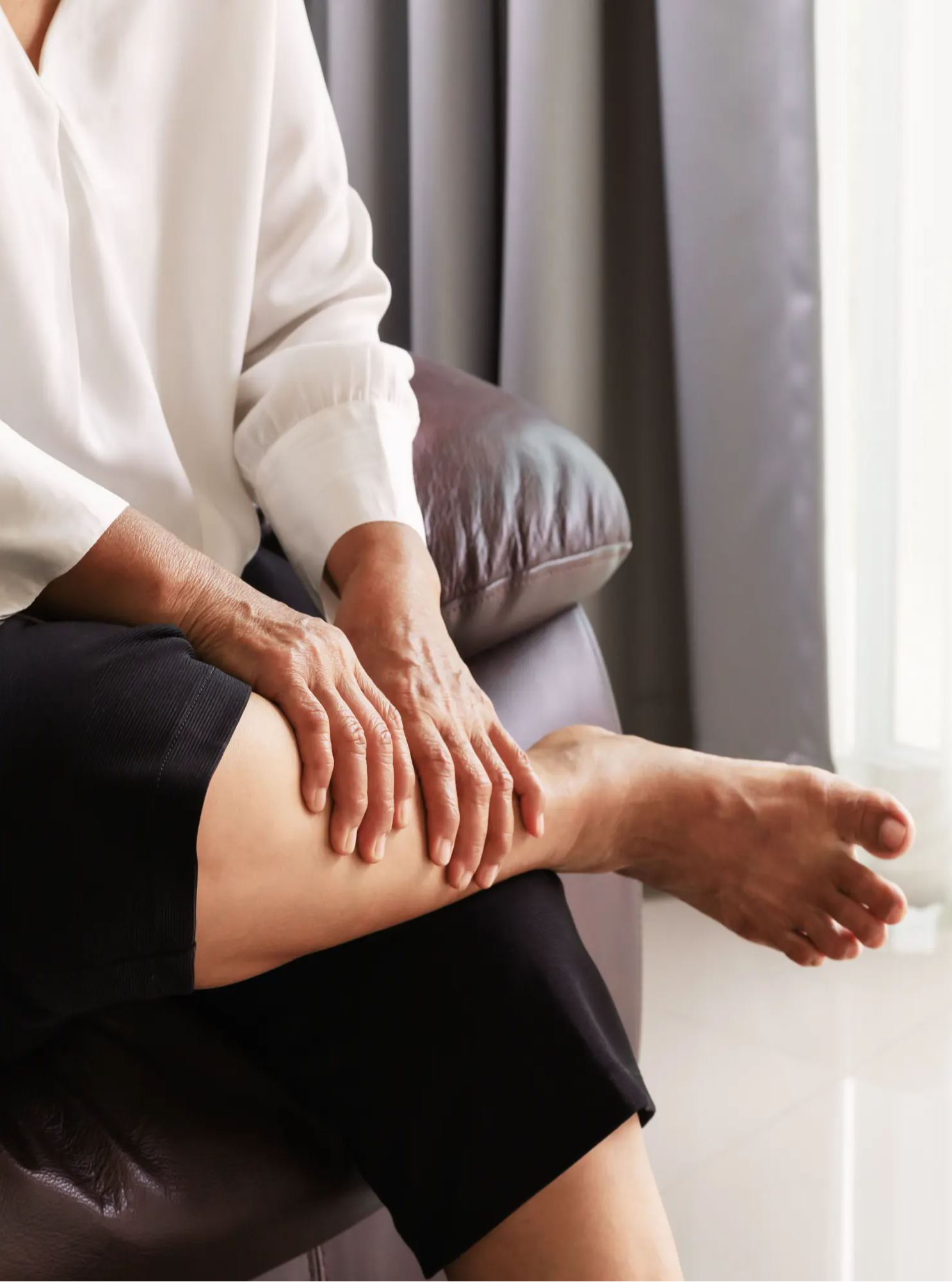 Woman holding leg, woman with leg pain