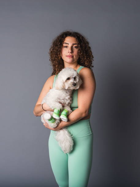 yoga girl holding white dog in studio