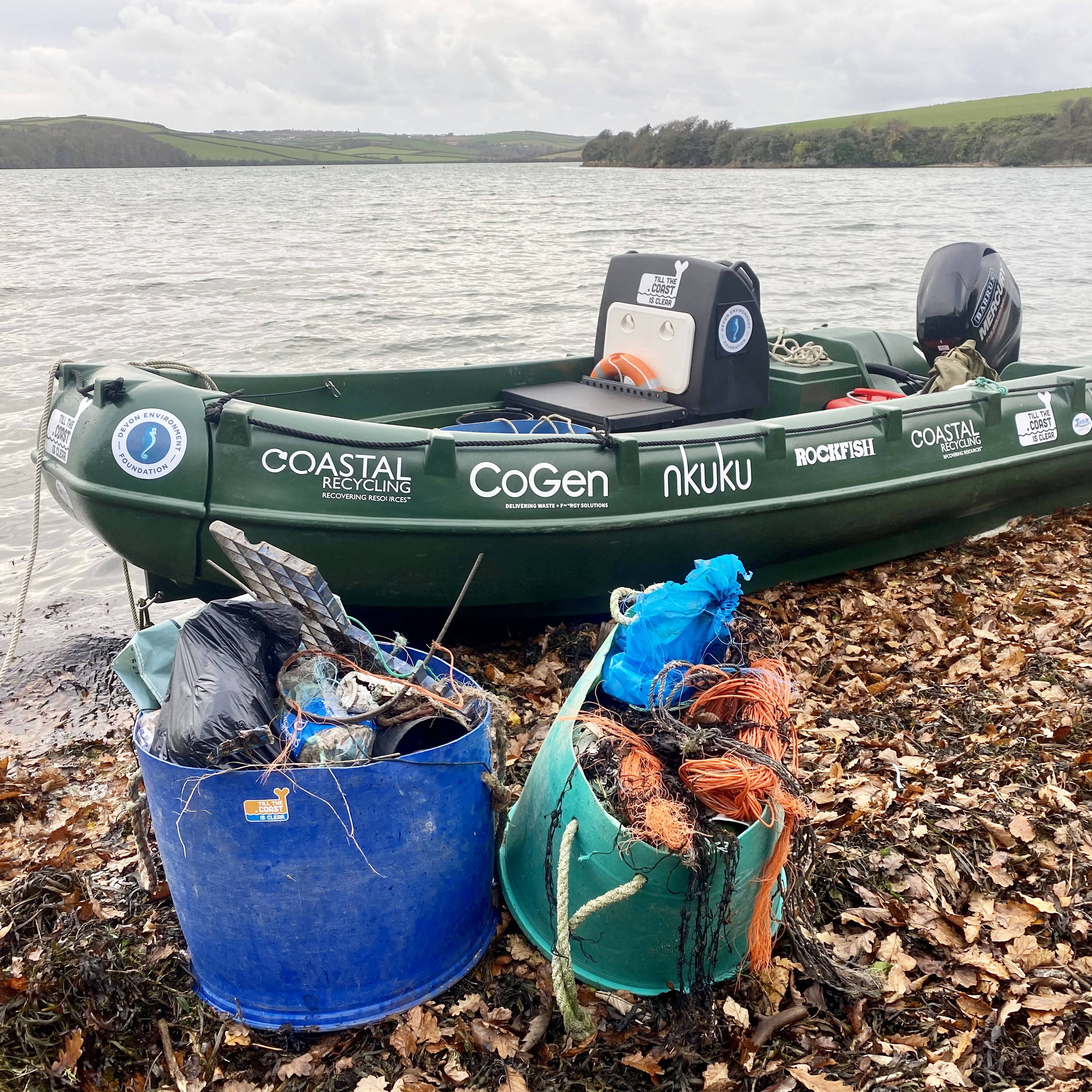 A blue tub collecting using for collecting debris on a beach in the south west.