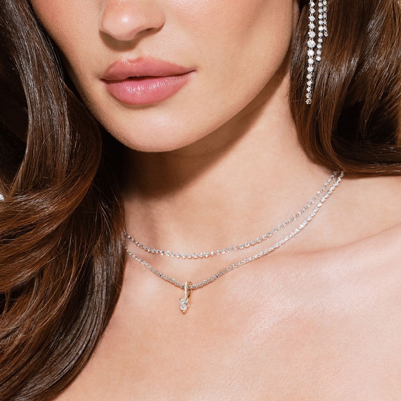 Close-up of a woman wearing silver jewelry and earrings.